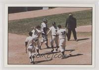 Maris homers on May 24, 1961, and is greeted by Yogi Berra and Johnny Blanchard