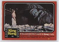 A heartbroken Dwan stands by Kong's body.
