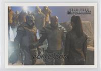 A nervous Uhura confronts a squad of armed Klingons...