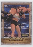 Kurt Angle and Ronda Rousey Def. Triple H and Stephanie McMahon #/172